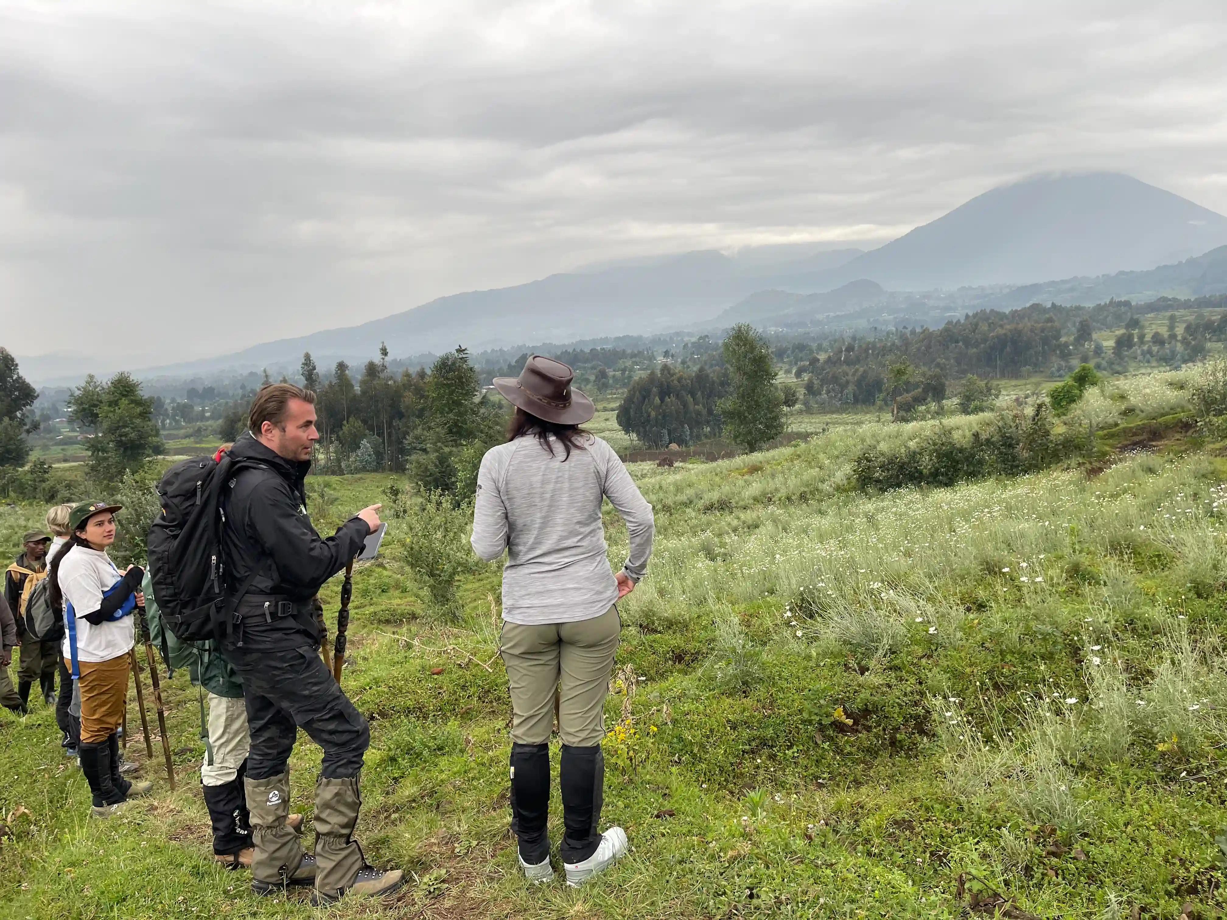 Guests trekking through Volcanoes National Park during a 4-Day Massive Mountain Gorilla Trekking in Rwanda Tour to see endangered mountain gorillas.