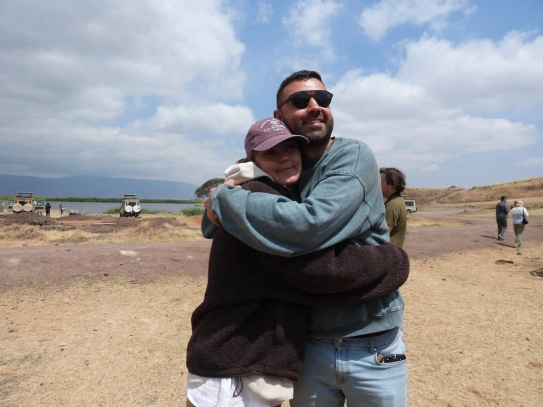 Guests in Ngorongoro hugging each other after big 5 game, waiting to continue for great migration in Serengeti