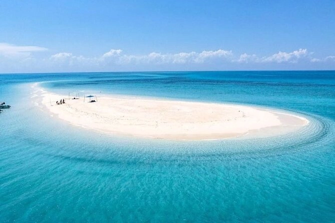 Nakupenda Beach Zanzibar at low tide with crystal-clear turquoise waters, white sandbanks, and traditional wooden boats — How To Visit & Experience Zanzibar: Ultimate Travel Guide.
