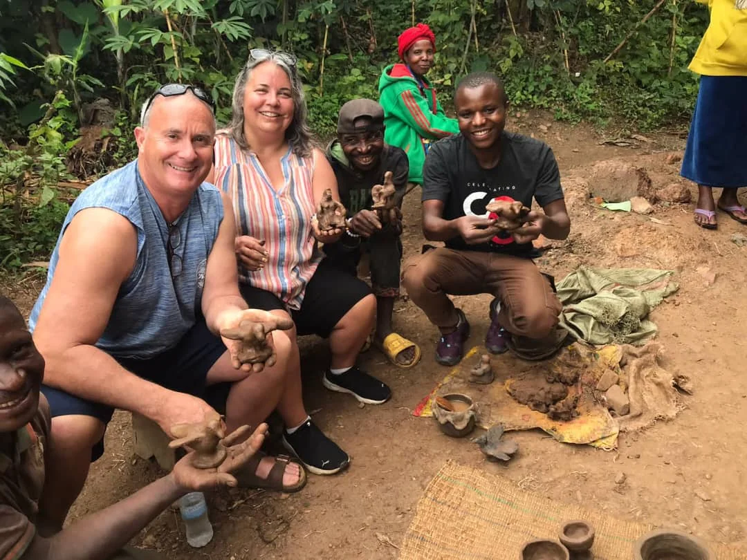 Travelers enjoying a cultural poetry experience along Rwanda’s scenic Congo Nile Trail, connecting with local storytellers and nature.