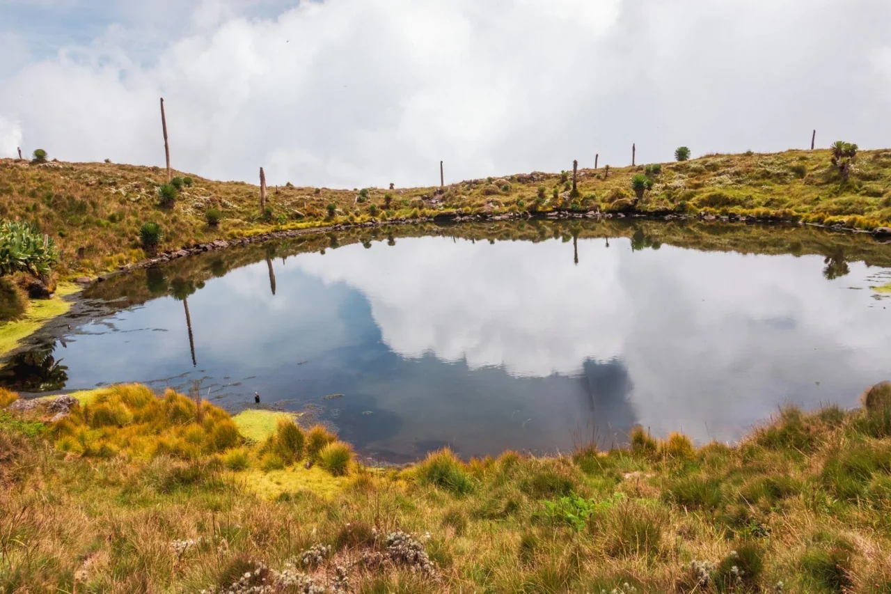 Muhabura Crater Lake view on one of the 10 best hiking tours and trails in Rwanda, showcasing stunning volcanic scenery and peaceful mountain landscapes.